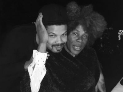 Jake Smollett is lying his head on Janet Smollett's shoulder from the back.